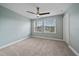 Bright bedroom boasts plush carpet, ceiling fan, and double windows for natural light at 5191 78Th St E Cir, Bradenton, FL 34203