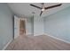 This bedroom features neutral carpet, fresh paint, and a ceiling fan at 5191 78Th St E Cir, Bradenton, FL 34203