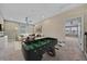 Spacious bonus room with a foosball table, living room furniture, and ceiling fan at 5191 78Th St E Cir, Bradenton, FL 34203