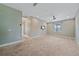 Large bonus room with carpet, television, and easy access to other rooms at 5191 78Th St E Cir, Bradenton, FL 34203