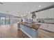 Spacious kitchen featuring white cabinets, a large island, and stainless steel appliances at 5191 78Th St E Cir, Bradenton, FL 34203