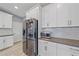 Kitchen boasts stainless steel appliances, white cabinets, and stone countertops at 5191 78Th St E Cir, Bradenton, FL 34203