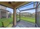 Relaxing screened lanai with seating, offering views of the backyard and community at 5191 78Th St E Cir, Bradenton, FL 34203