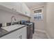 Bright laundry room with modern appliances, sink, and ample storage space at 5191 78Th St E Cir, Bradenton, FL 34203