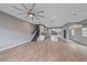Bright open floor plan featuring wood-look tile flooring, staircase, and kitchen at 5191 78Th St E Cir, Bradenton, FL 34203