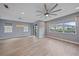 Bright open floor plan features wood-look tile flooring, modern lighting, and large windows at 5191 78Th St E Cir, Bradenton, FL 34203