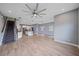 Open-concept living space with stairs, kitchen, tiled floors, and modern lighting at 5191 78Th St E Cir, Bradenton, FL 34203