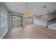 Open-concept living space with tiled floors, stairs, and sliding glass doors to the patio at 5191 78Th St E Cir, Bradenton, FL 34203