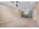 Upstairs loft area with neutral carpet, ceiling fan, and access to other rooms at 5191 78Th St E Cir, Bradenton, FL 34203
