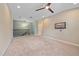 Neutral upstairs loft features carpet, ceiling fan, and mounted television at 5191 78Th St E Cir, Bradenton, FL 34203