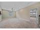 Upstairs loft area featuring neutral carpet, ceiling fan, and open doorway at 5191 78Th St E Cir, Bradenton, FL 34203