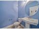 Stylish powder room with a pedestal sink, toilet and whimsical decor at 5191 78Th St E Cir, Bradenton, FL 34203
