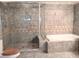 Modern bathroom featuring a glass-enclosed shower, soaking tub, and elegant tile work, creating a spa-like atmosphere at 5439 3Rd E St, Bradenton, FL 34203