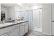 Bright bathroom with double sinks, spacious shower, and ample storage at 5659 Woodland Sage Dr, Sarasota, FL 34238