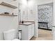 A well-lit bathroom showcases stylish floating shelves and vanity at 5659 Woodland Sage Dr, Sarasota, FL 34238