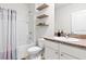 Bright bathroom features a shower-tub combo and modern fixtures at 5659 Woodland Sage Dr, Sarasota, FL 34238