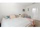 Comfortable bedroom with neutral tones, a cozy chair and bedside table at 5659 Woodland Sage Dr, Sarasota, FL 34238