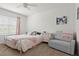 Bright bedroom with a ceiling fan, cozy decor and ample natural light at 5659 Woodland Sage Dr, Sarasota, FL 34238