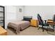 Serene bedroom with a stylish gaming chair, simple decor, neutral walls, and natural lighting at 5659 Woodland Sage Dr, Sarasota, FL 34238