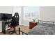 Bright bedroom featuring a desk, neutral-toned walls, a window, and a gaming chair at 5659 Woodland Sage Dr, Sarasota, FL 34238