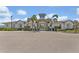 Community clubhouse featuring secure gated entrance, mature landscaping and convenient parking at 5659 Woodland Sage Dr, Sarasota, FL 34238