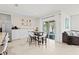 Open dining and kitchen area with sliding glass doors to the patio at 5659 Woodland Sage Dr, Sarasota, FL 34238
