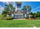 Community entrance with a decorative monument, lush landscaping, and clear signage for Promenade Estates at 5659 Woodland Sage Dr, Sarasota, FL 34238