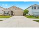 Beautiful home featuring lush landscaping and a two-car garage at 5659 Woodland Sage Dr, Sarasota, FL 34238