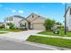 Charming single-Gathering home showcases a beautifully manicured lawn at 5659 Woodland Sage Dr, Sarasota, FL 34238