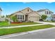 Charming single-Gathering home featuring a well-manicured lawn, neutral exterior, and a two-car garage at 5659 Woodland Sage Dr, Sarasota, FL 34238