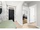 Bright foyer with patterned wallpaper, tiled floors, and views into the bedroom and additional hallway at 5659 Woodland Sage Dr, Sarasota, FL 34238