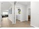 Hallway leading to a laundry area and living spaces, with neutral paint and tile flooring throughout at 5659 Woodland Sage Dr, Sarasota, FL 34238
