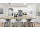 Island with granite countertops, seating, and stainless steel dishwasher at 5659 Woodland Sage Dr, Sarasota, FL 34238