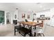 Open kitchen and dining area with pendant lights, granite counters and island at 5659 Woodland Sage Dr, Sarasota, FL 34238