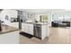 Open concept kitchen with island, stainless appliances, and dining area at 5659 Woodland Sage Dr, Sarasota, FL 34238