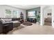 Comfortable living room showcasing tile floors, a plush couch, entertainment center, and natural light at 5659 Woodland Sage Dr, Sarasota, FL 34238