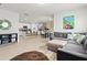 Open concept living space connecting the living room and kitchen with an oversized couch and breakfast bar at 5659 Woodland Sage Dr, Sarasota, FL 34238