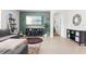 Inviting living room featuring tile floors, a cozy couch, entertainment center and neutral tones at 5659 Woodland Sage Dr, Sarasota, FL 34238