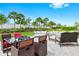 Outdoor patio with comfortable seating, a table and manicured landscaping at 5659 Woodland Sage Dr, Sarasota, FL 34238
