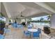 Relaxing pool area with ample seating, covered patio, and scenic views of lush surroundings at 5659 Woodland Sage Dr, Sarasota, FL 34238