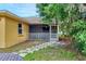 The backyard features a screened-in patio with a paver walkway leading to the house at 5823 Helen Way, Sarasota, FL 34243