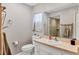 The neutral bathroom has a tile shower and vanity with updated fixtures at 5823 Helen Way, Sarasota, FL 34243