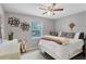 Comfortable bedroom with a ceiling fan, charming decor, and a window providing natural light at 5823 Helen Way, Sarasota, FL 34243