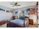 Charming bedroom features a wood frame bed and dresser, posters, and a window offering natural light at 5823 Helen Way, Sarasota, FL 34243