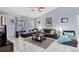 Comfortable living room with a ceiling fan, tile flooring, and a large sectional sofa at 5823 Helen Way, Sarasota, FL 34243