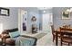 Bright living area with tile floors, comfortable seating, and open doorway to bedroom at 5823 Helen Way, Sarasota, FL 34243
