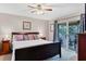 The main bedroom includes a ceiling fan, ensuite bathroom, and sliding door access to the screened-in lanai at 5823 Helen Way, Sarasota, FL 34243