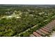 Expansive aerial view of a community featuring lush landscaping and a tranquil pond at 601 Suffolk Cir, Nokomis, FL 34275