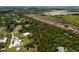 A landscape shot of upscale homes and ponds nestled among dense trees, featuring modern amenities and a scenic setting at 601 Suffolk Cir, Nokomis, FL 34275