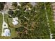 An aerial view highlights a luxury house amidst lush trees, offering privacy and seclusion in a natural setting at 601 Suffolk Cir, Nokomis, FL 34275